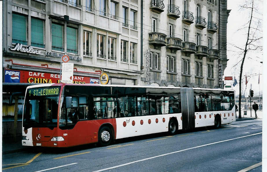 (052'115) - TPF Fribourg - Nr. 584/FR 300'392 - Mercedes am 17. Februar 2002 beim Bahnhof Fribourg