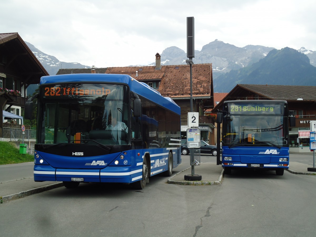 (146'150) - AFA Adelboden - Nr. 57/BE 272'798 - Scania/Hess + Nr. 56/BE 611'030 - MAN/Gppel am 28. Juli 2013 beim Bahnhof Lenk
