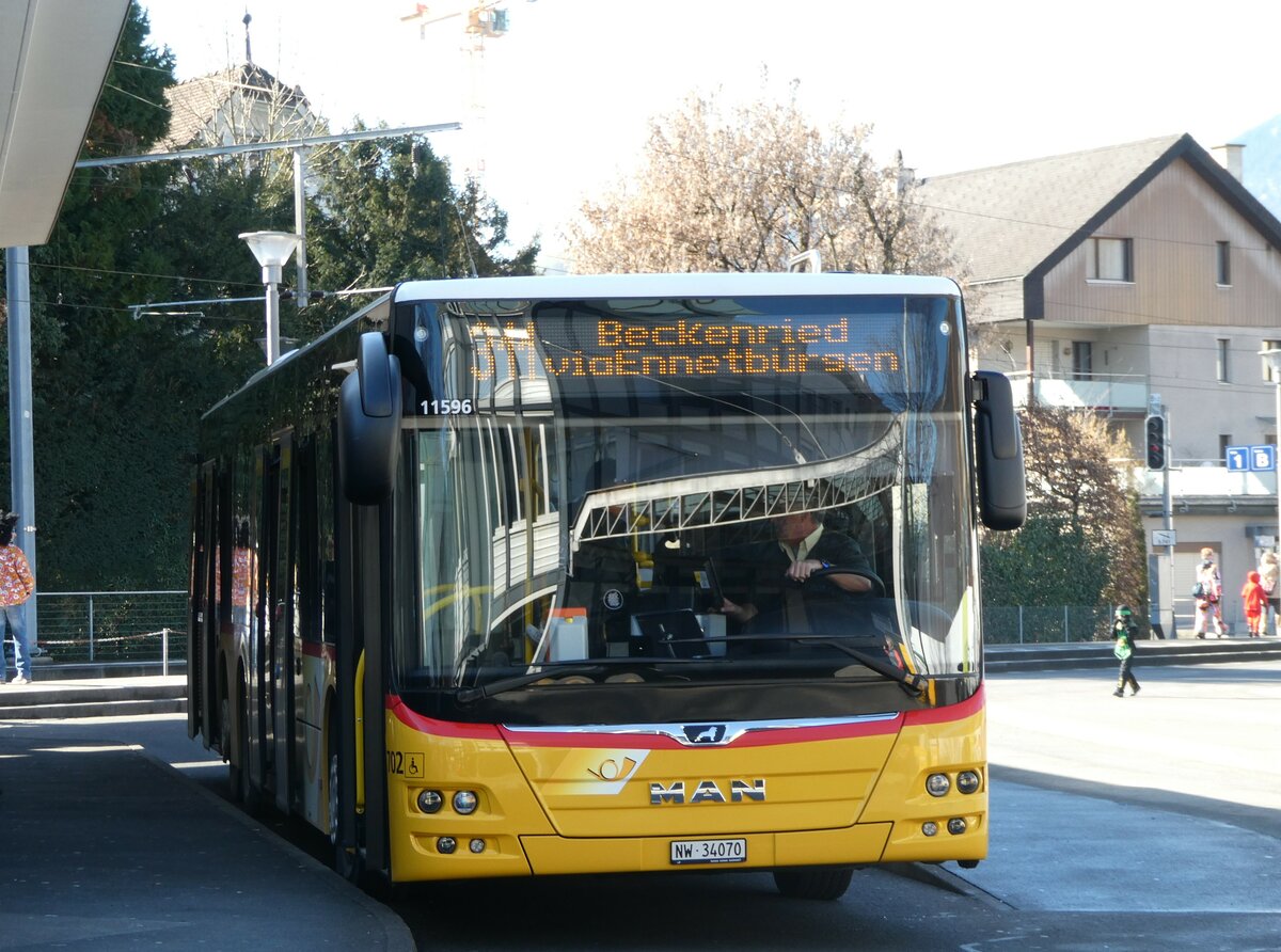 (246'174) - PostAuto Zentralschweiz - Nr. 702/NW 34'070/PID 11'596 - MAN (ex Nr. 72) am 16. Februar 2023 beim Bahnhof Stans