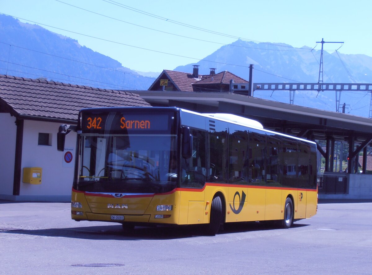 (289'976) - PostAuto Zentralschweiz - OW 26'301/PID 12'338 - MAN (ex Nr. 530; ex Dr. Richard, A-Wien Nr. 1418) am 28. Juli 2026 beim Bahnhof Alpnach-Dorf