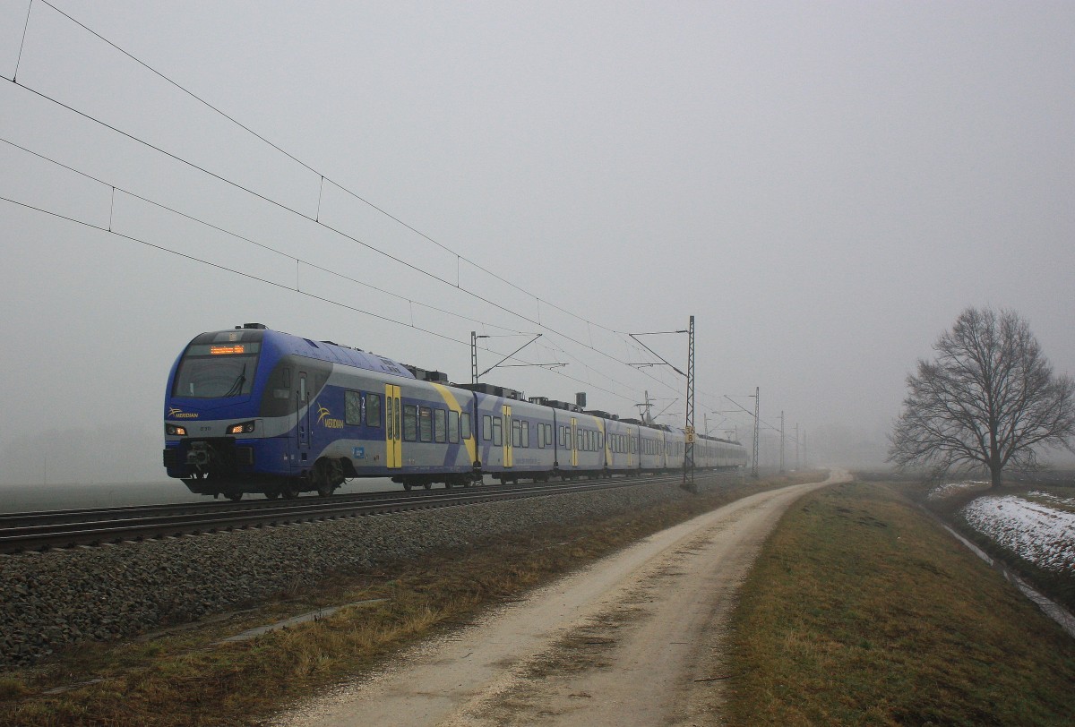 ET 311 am 2. Februar 2014 aus den Nebel kommend bei �bersee am Chiemsee.