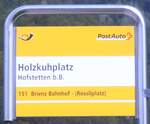 (290'464) - PostAuto-Haltestellenschild - Hofstetten b.B., Holzkuhplatz - am 27. August 2026